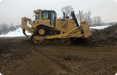 Construction machine pushing dirt